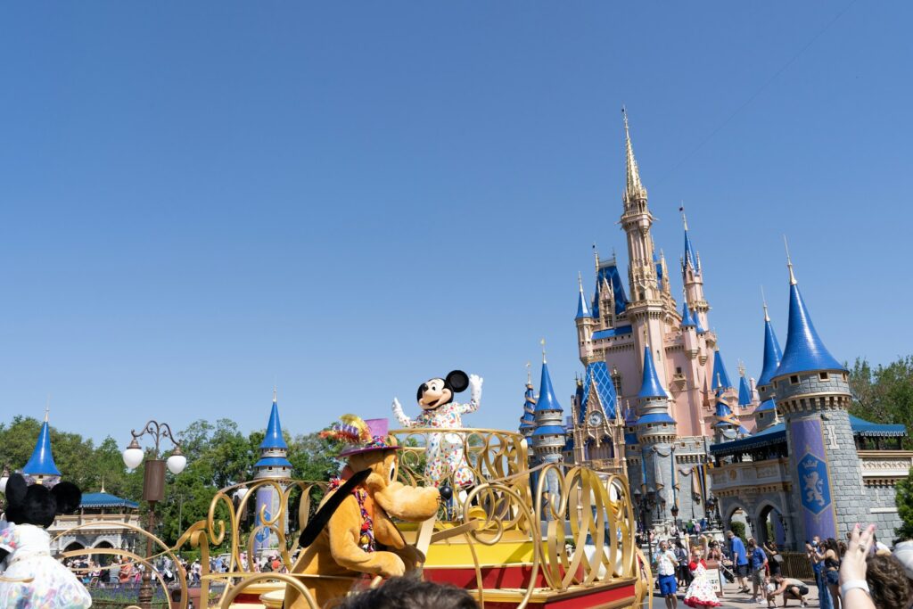 people riding on yellow and blue carousel during daytime